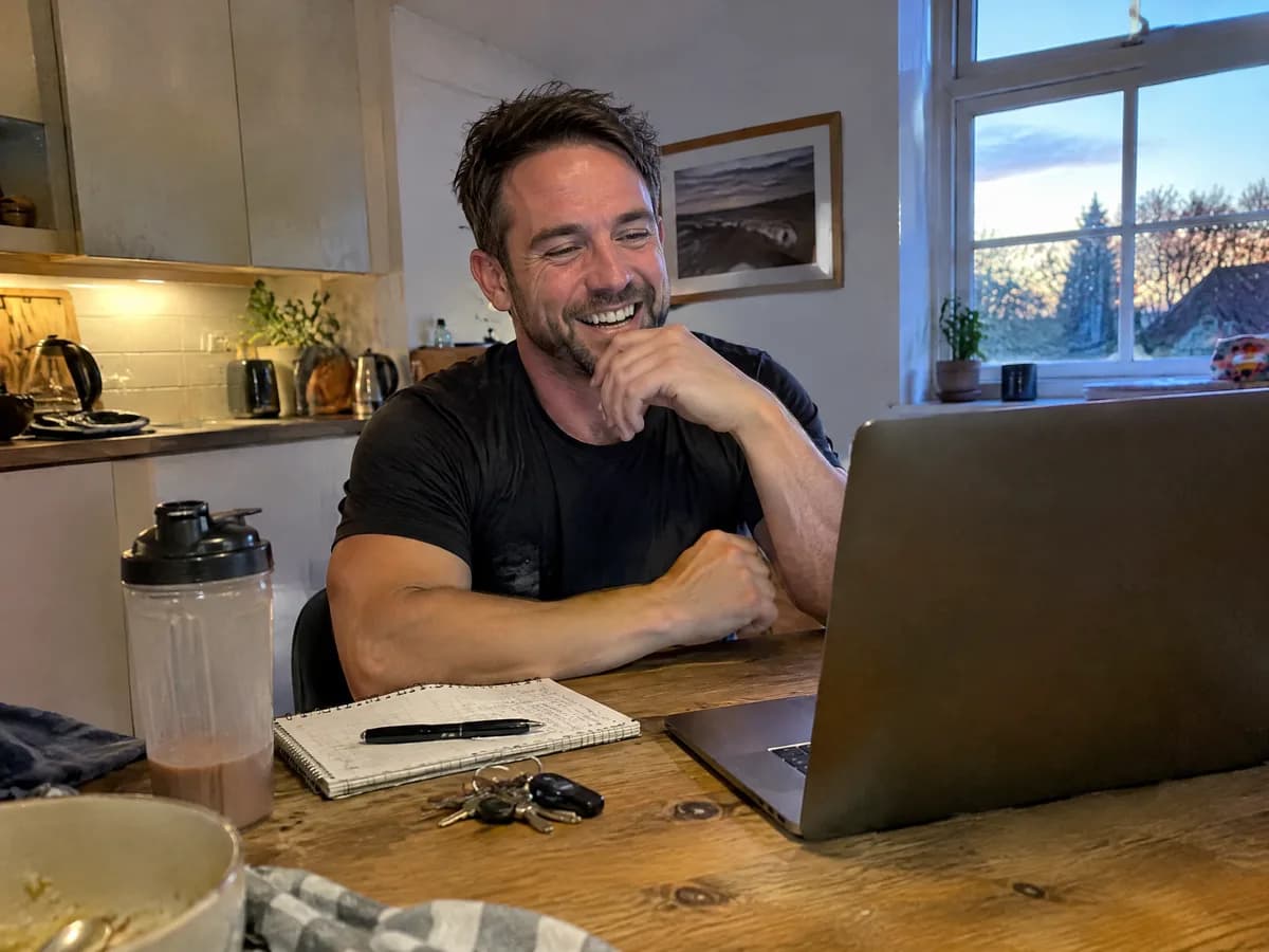 A coach smiling during a video call