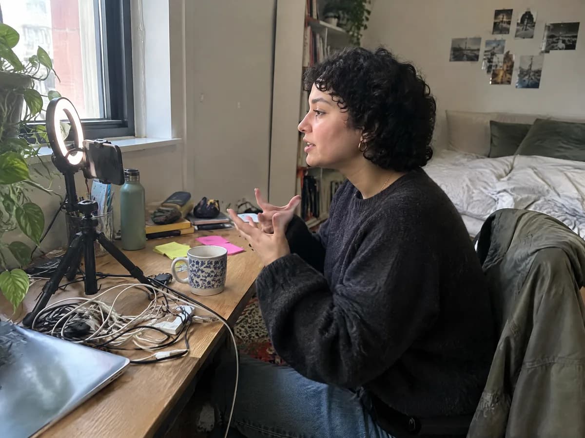 A creator filming a short video at her desk